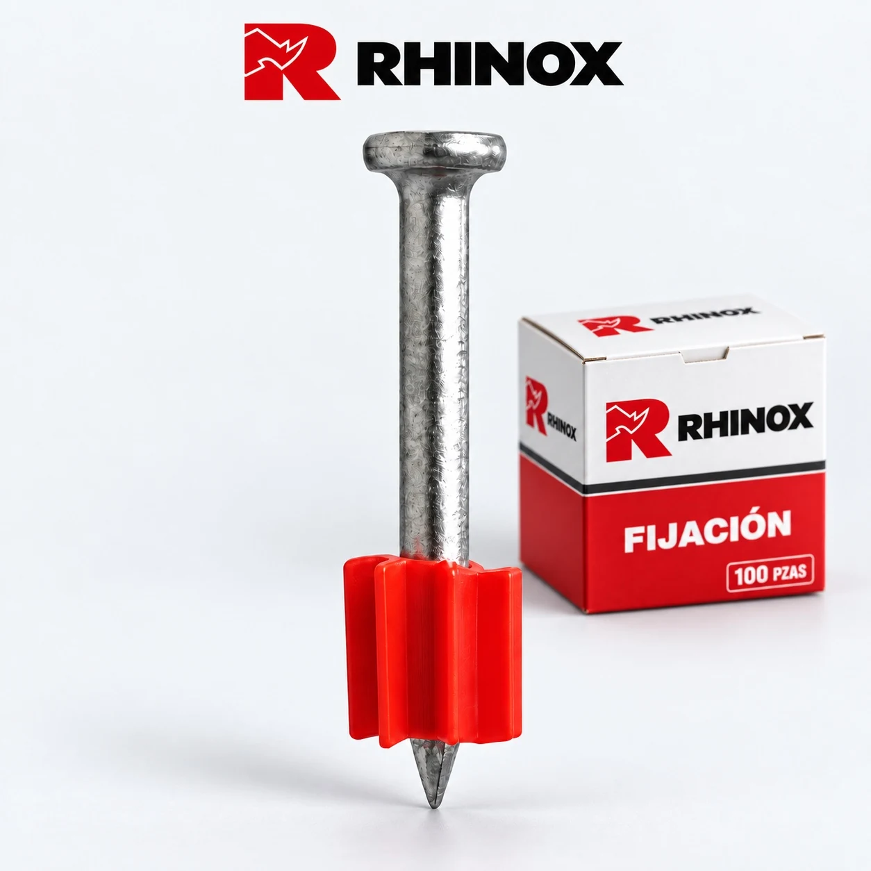 Un clavo plateado con camisa plástica roja y caja RHINOX de 100 piezas